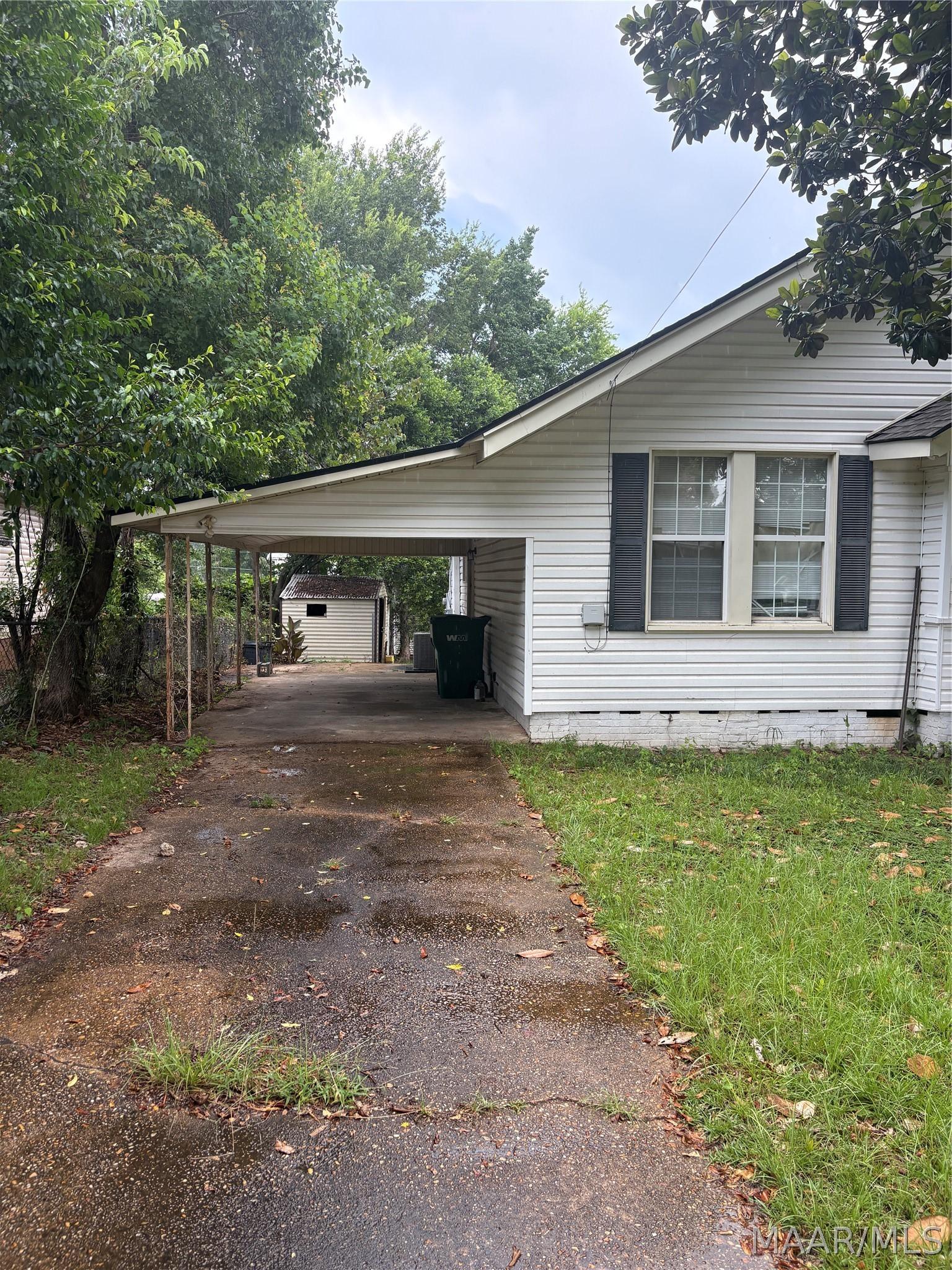 Image 1: Driveway with Carport