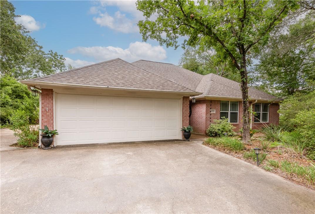 Image 2: Ranch-style house with brick siding, concrete driv