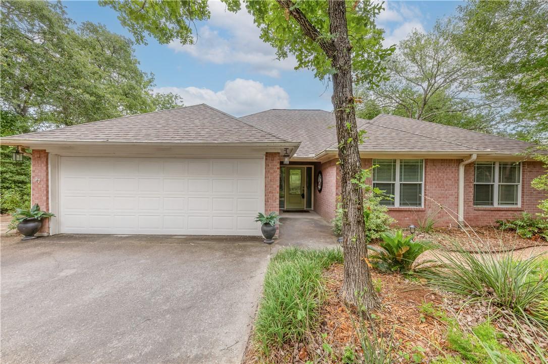 Image 3: Single story home with brick siding, an attached g