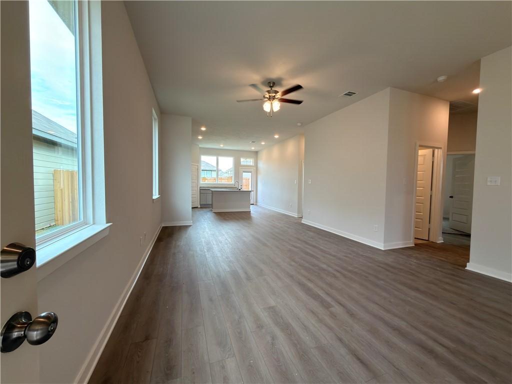 Image 2: Unfurnished living room featuring dark wood-style