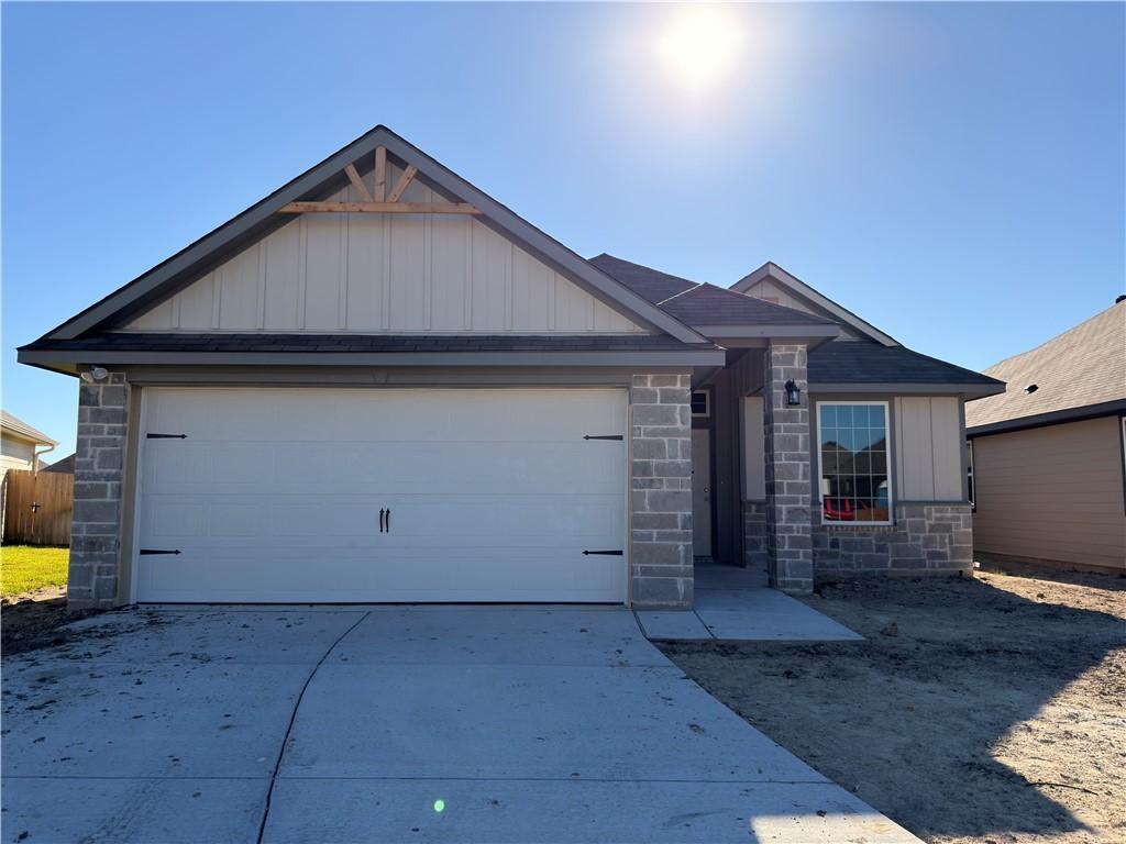 Image 1: Ranch-style home featuring stone siding, board and