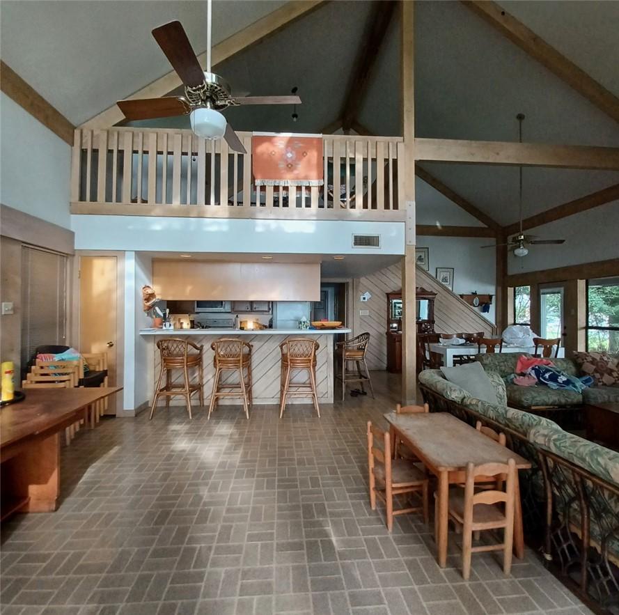 Image 2: Living area with ceiling fan, high vaulted ceiling