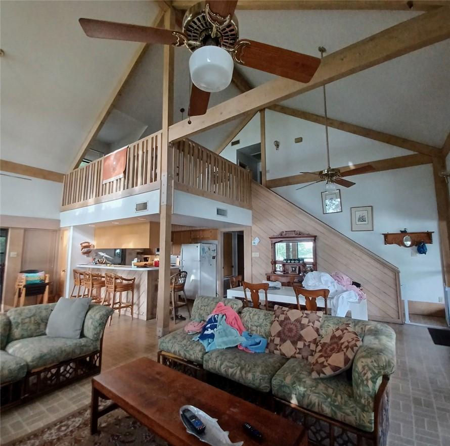 Image 3: Living room featuring high vaulted ceiling, a ceil