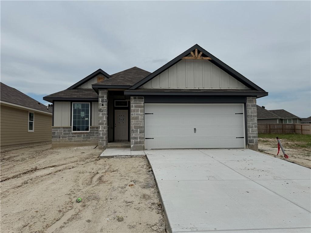 Image 1: View of front of house featuring driveway, board a