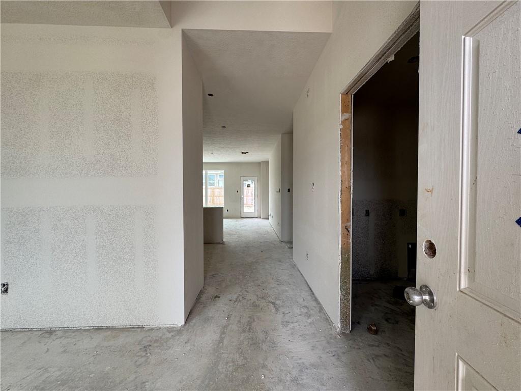 Image 2: Corridor with unfinished concrete flooring