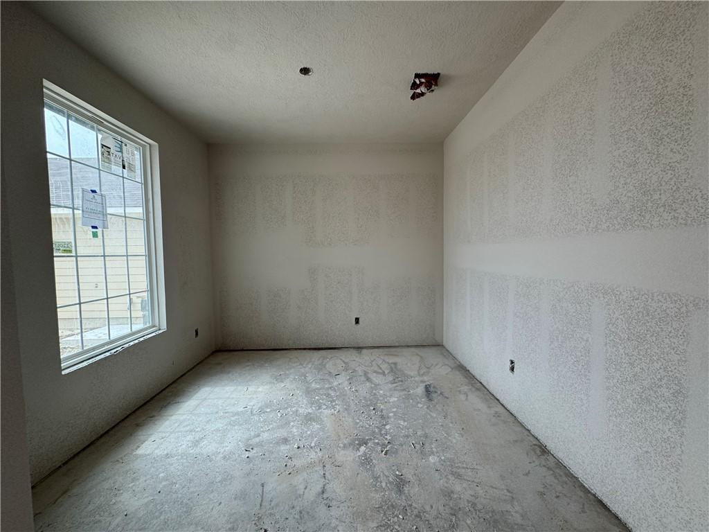 Image 3: Unfurnished room with a textured ceiling