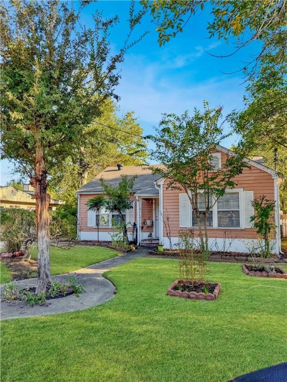 Image 1: Bungalow-style house featuring a front lawn