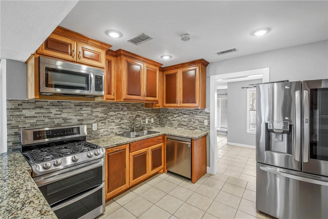 Image 3: Kitchen featuring appliances with stainless steel