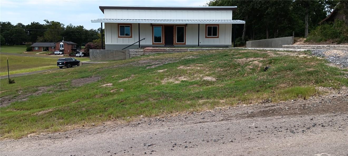 Image 2: View of front of property with board and batten si