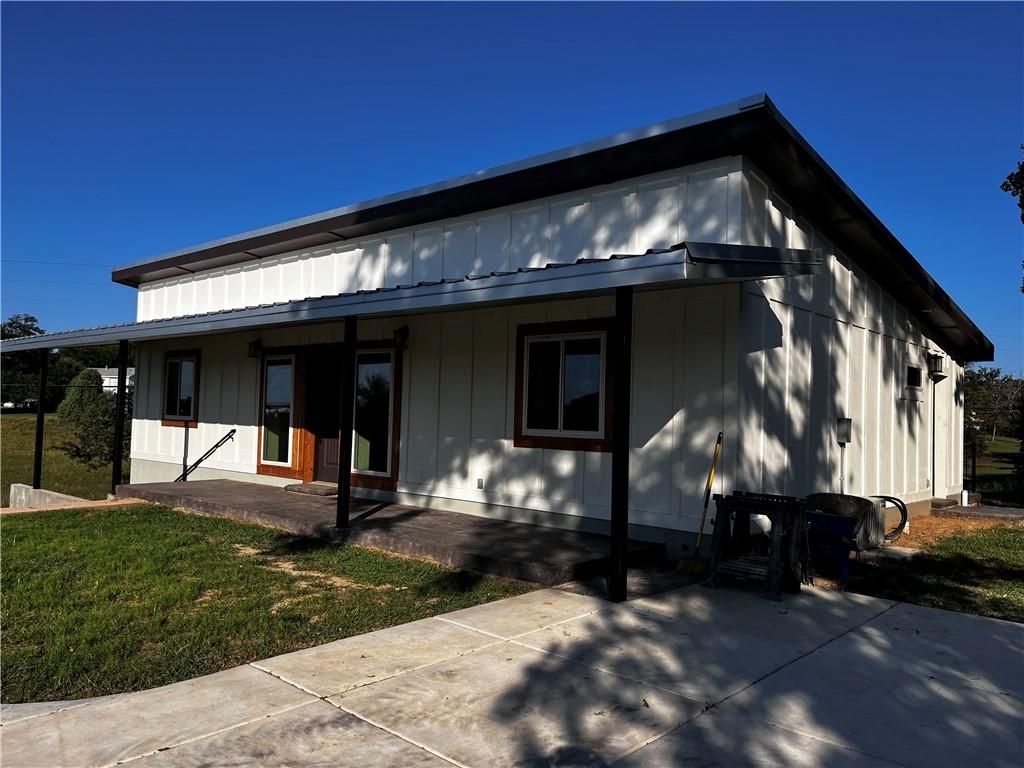 Image 4: Back of property with a porch and a lawn
