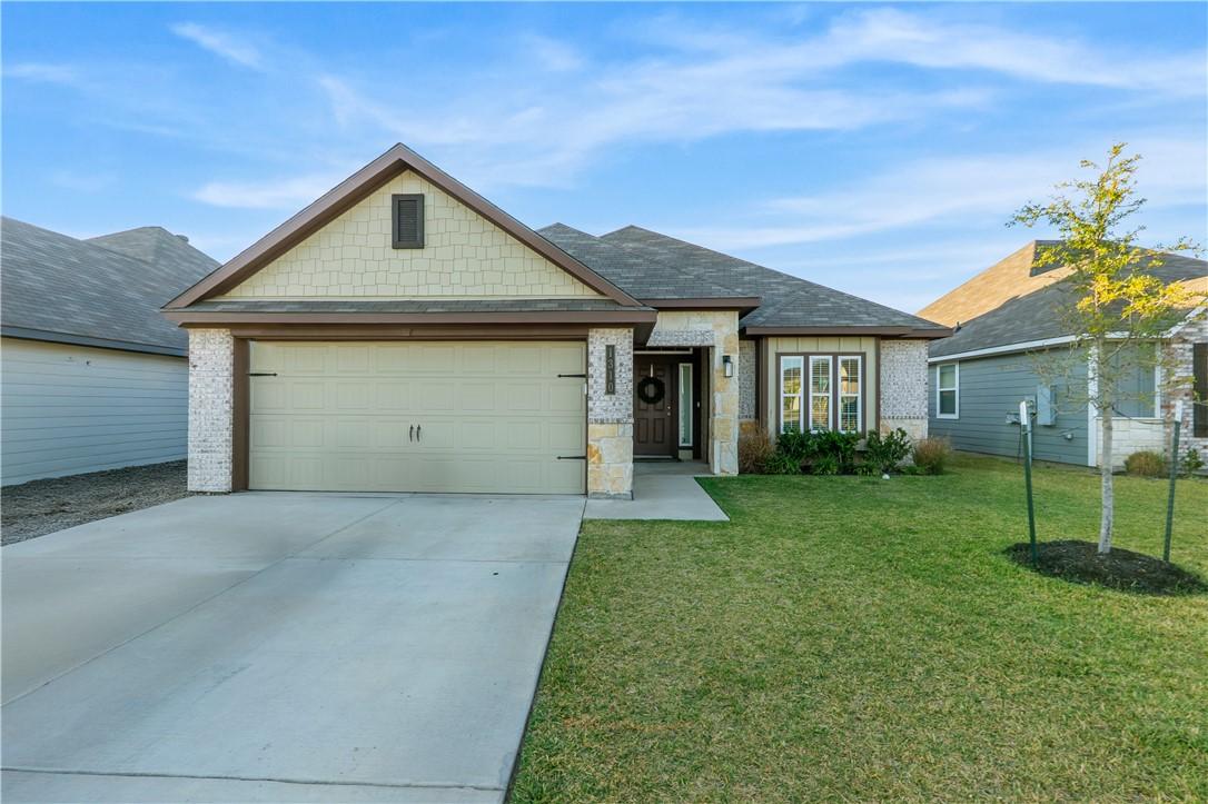 Image 1: View of front of property featuring a front yard,