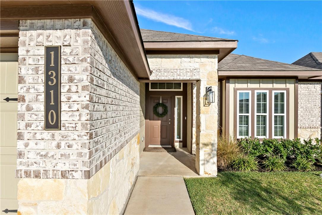 Image 2: Property entrance with stone siding, roof with shi