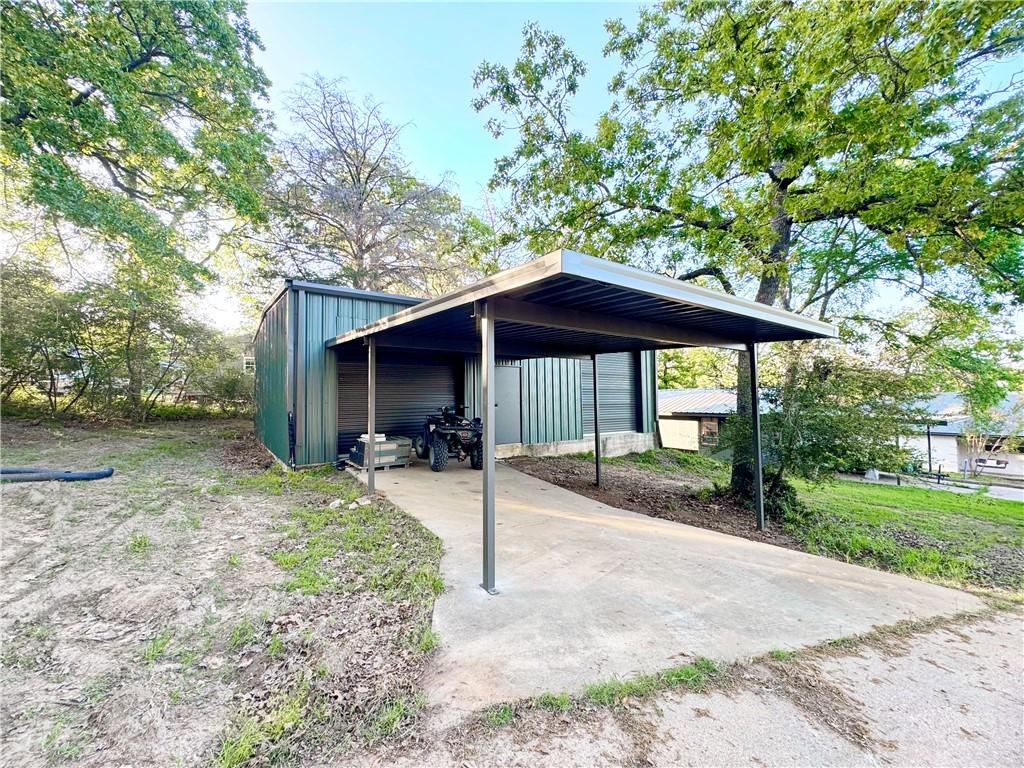 Image 4: View of parking with a detached garage