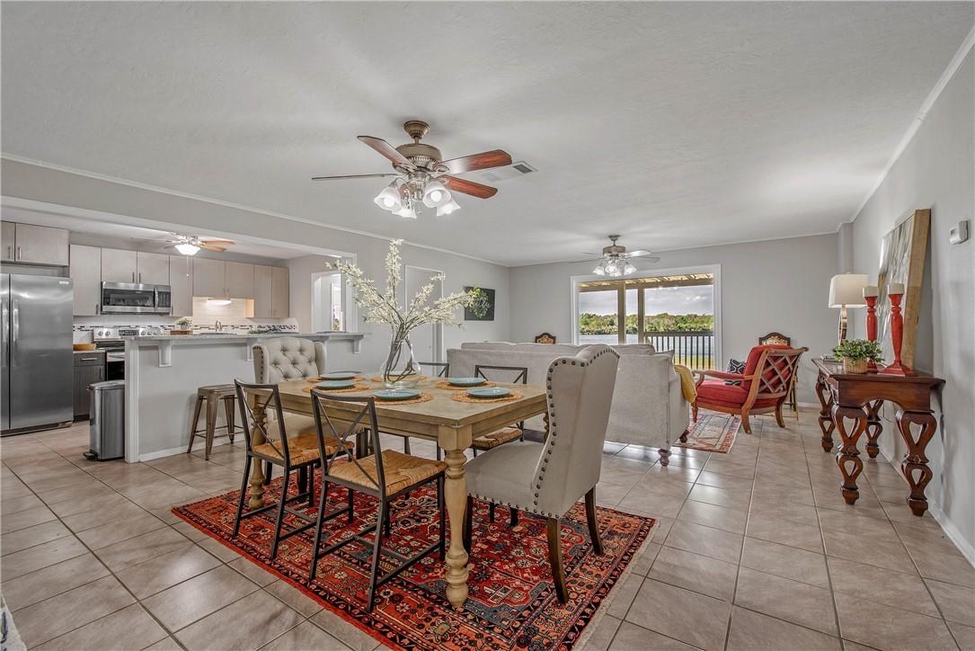 Image 4: Dining area featuring light tile patterned floors