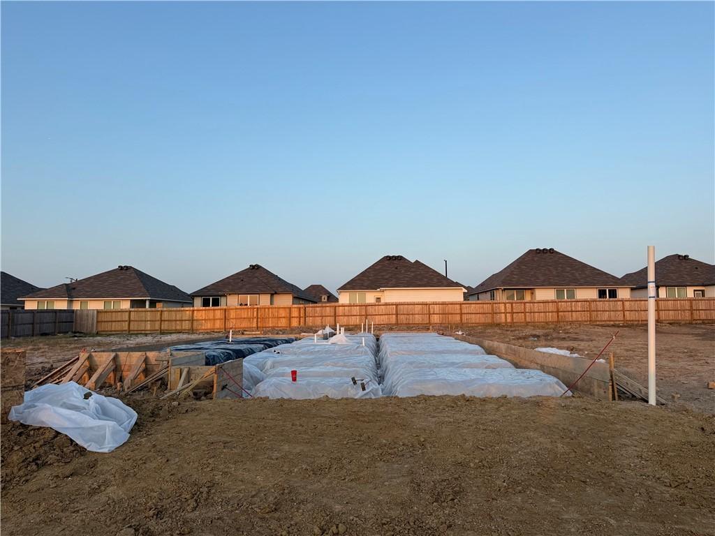 Image 1: Fenced backyard featuring a residential view
