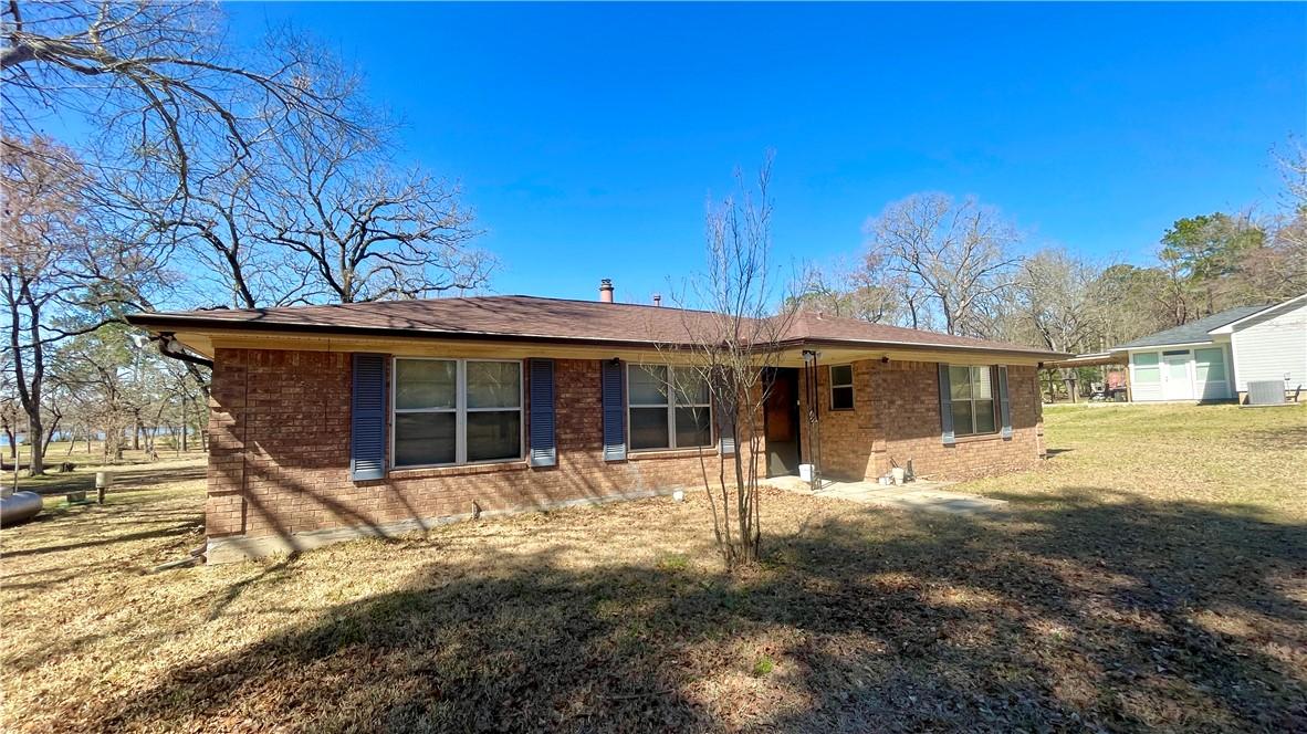 Image 3: Ranch-style home featuring brick siding and a fron