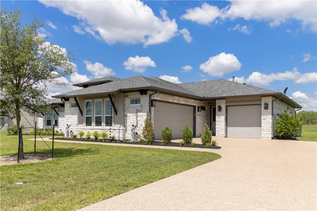 Image 1: Prairie-style house with a garage, stone siding, d