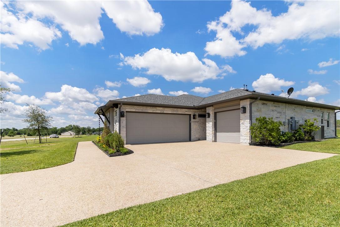 Image 4: View of front of home featuring a garage, a front