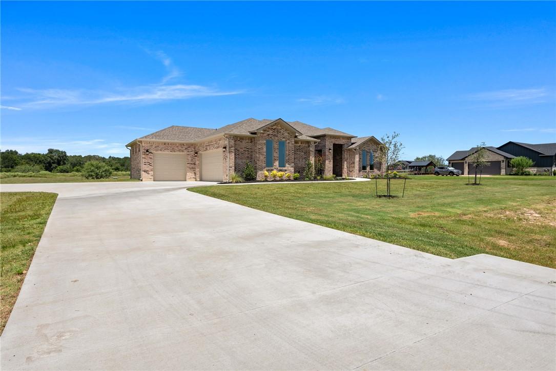 Image 4: View of front facade featuring driveway, an attach