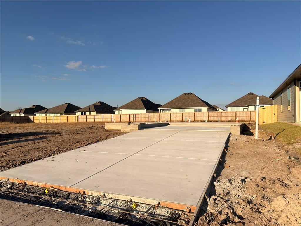 Image 1: Fenced backyard featuring a residential view