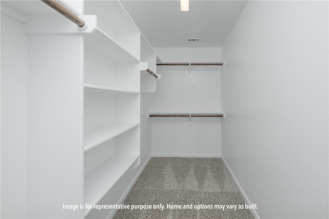 Image 3: Spacious closet featuring light colored carpet