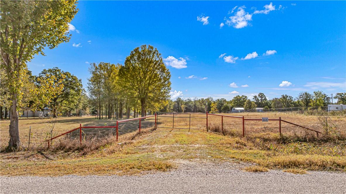 Image 3: View of dirt / gravel road featuring a view of cou