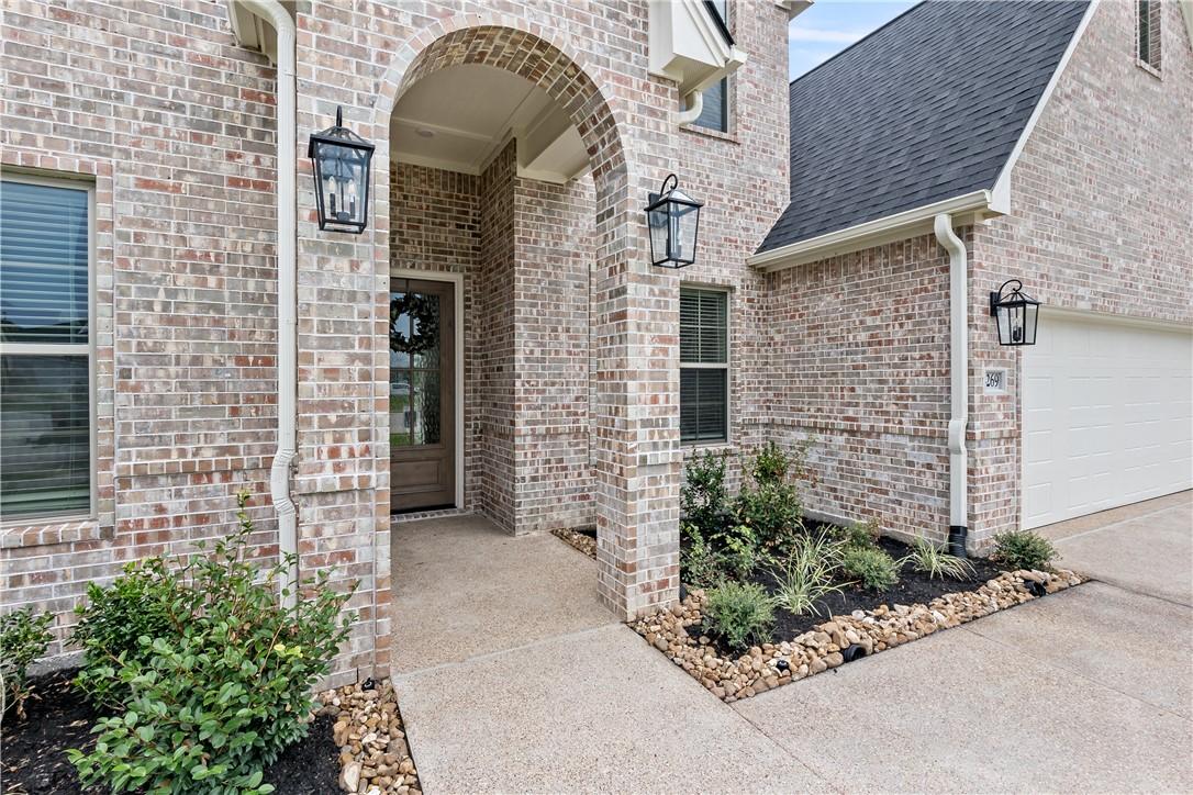 Image 3: Doorway to property with brick siding and roof wit