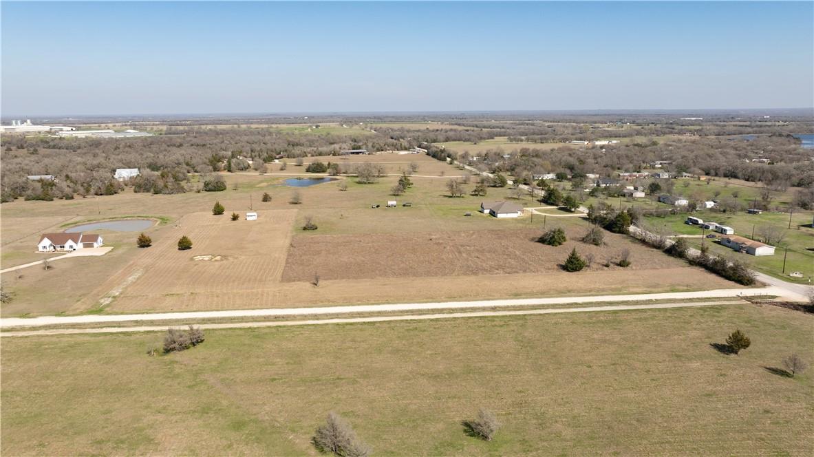 Image 2: View of rural area featuring a large body of water