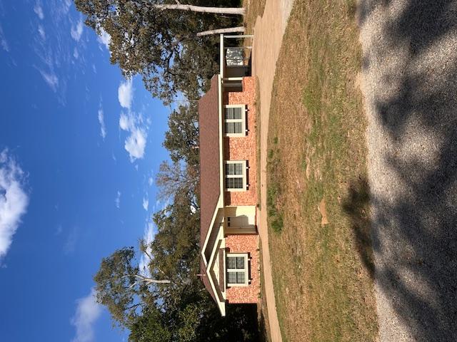 Image 1: Ranch-style house with concrete driveway, a front