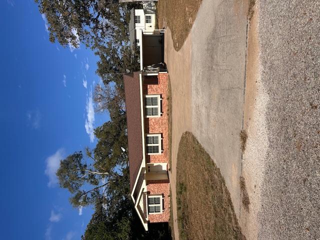 Image 2: Ranch-style home featuring concrete driveway, a ca