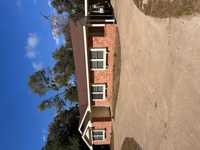 Image 4: Single story home with driveway, a carport, roof w