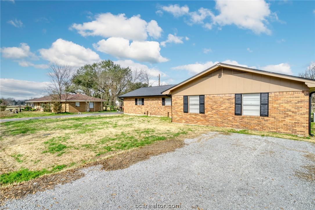 Image 3: View of property exterior featuring brick siding a