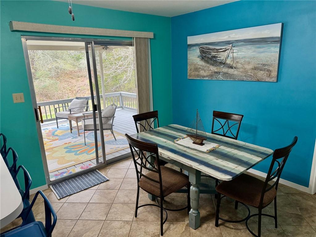 Image 4: Tiled dining area that opens to the deck.
