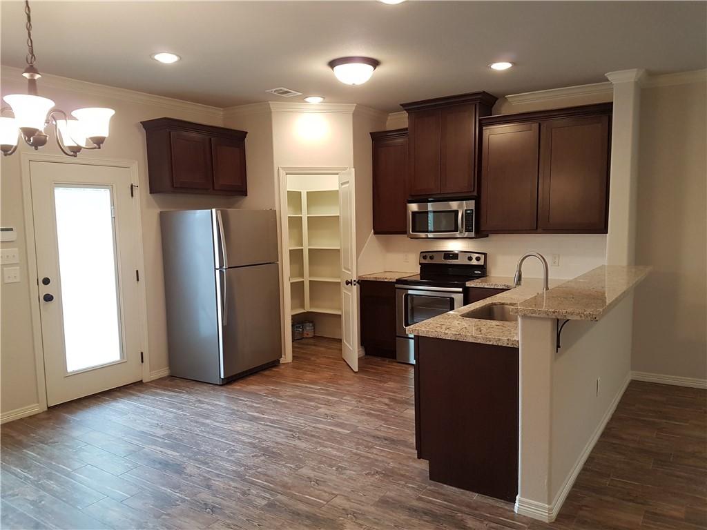 Image 2: Kitchen with visible vents, dark brown cabinets, a