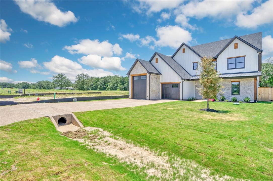 Image 3: Modern farmhouse style home with concrete driveway
