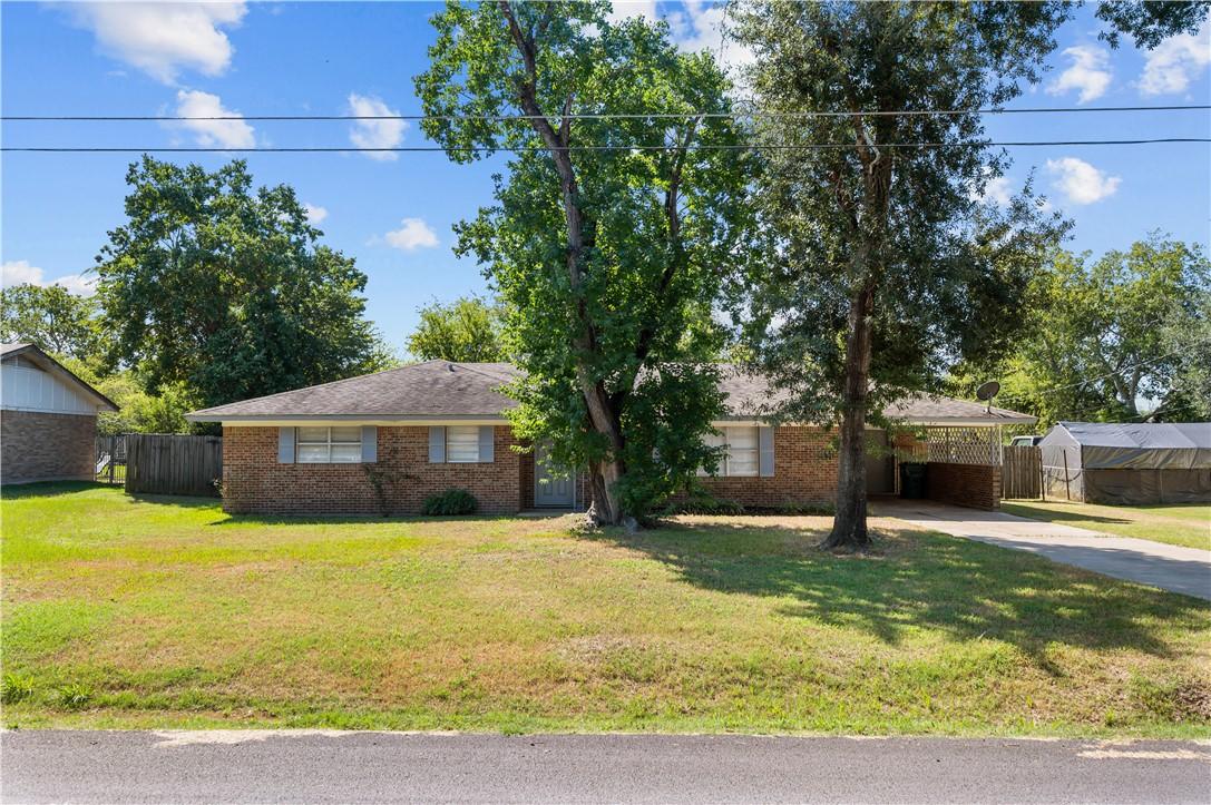 Image 1: Ranch-style home featuring brick siding, concrete