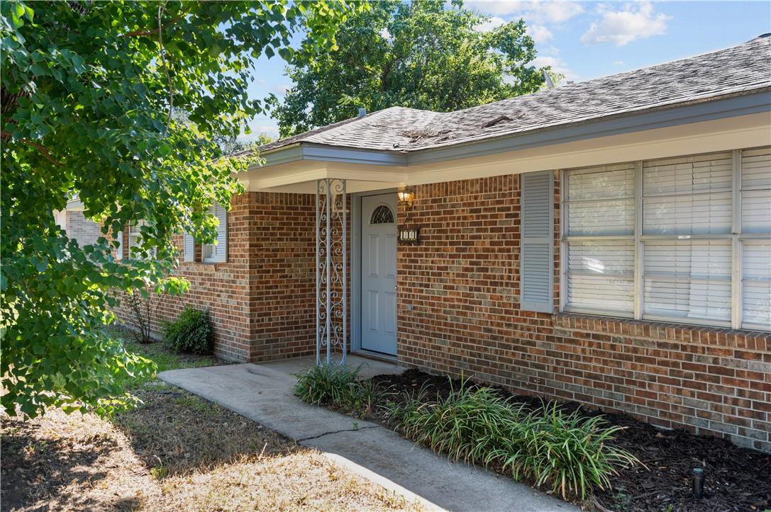 Image 2: View of exterior entry with brick siding