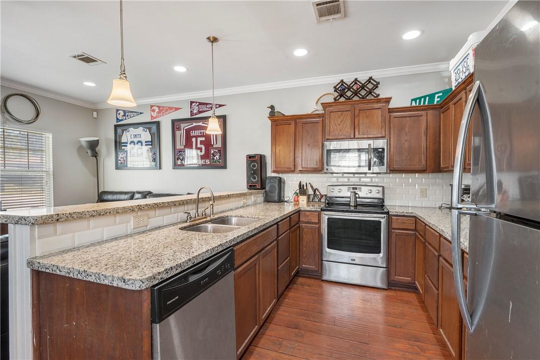 Image 3: Kitchen featuring a peninsula, appliances with sta