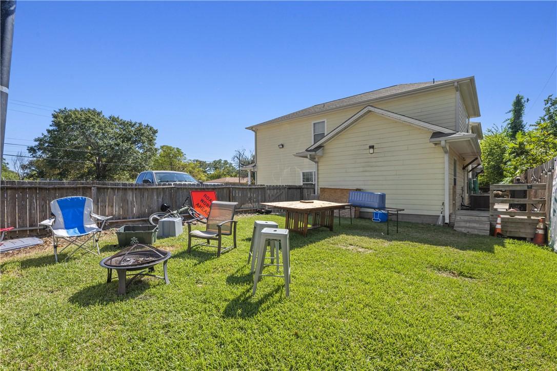 Image 4: Rear view of house featuring a fenced backyard and