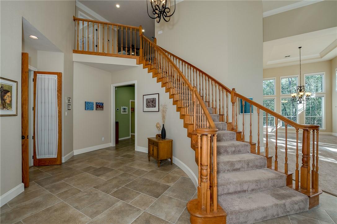 Image 4: A dramatic staircase is just off the home's entry
