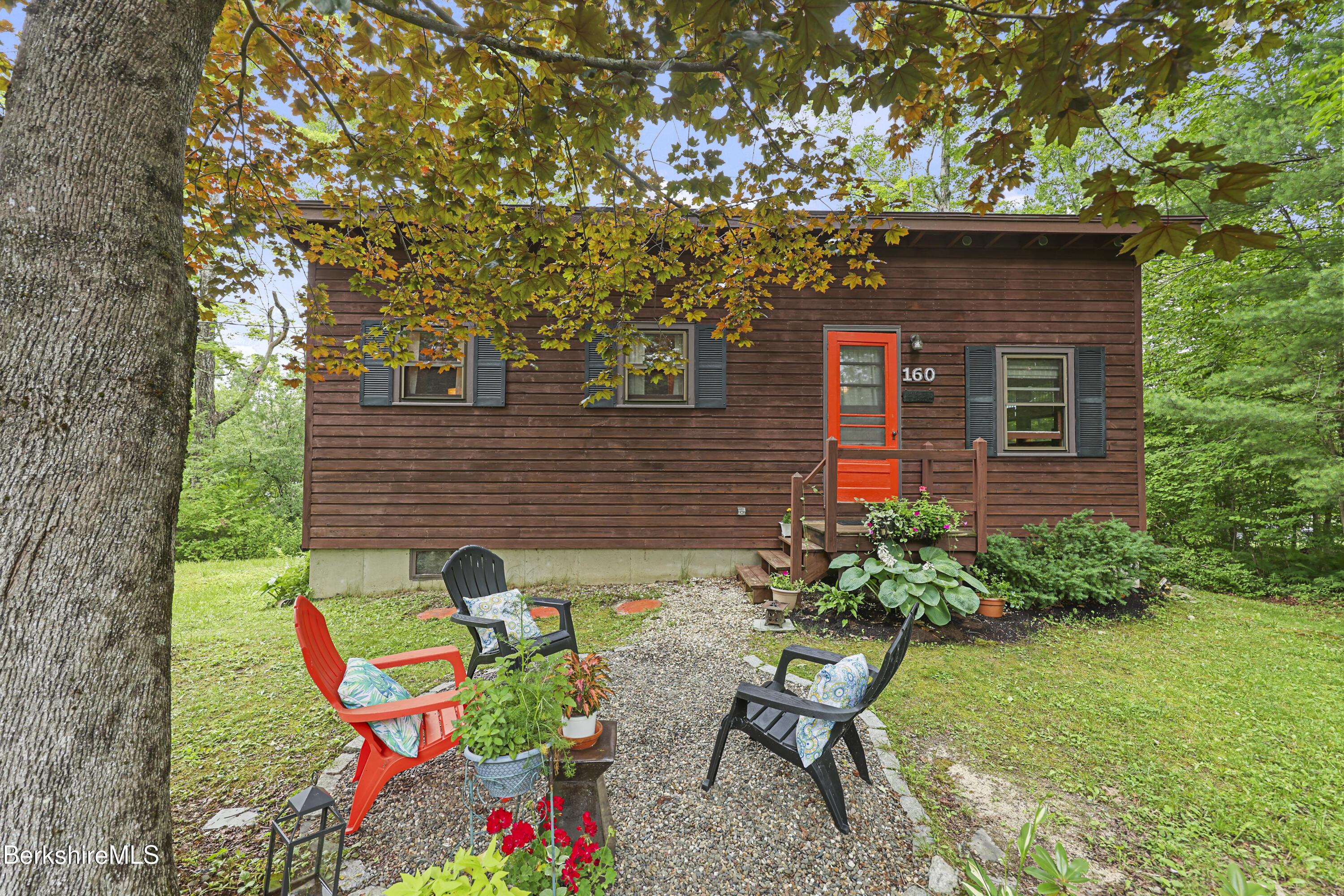 Image 3: Front Yard w/ gravel patio