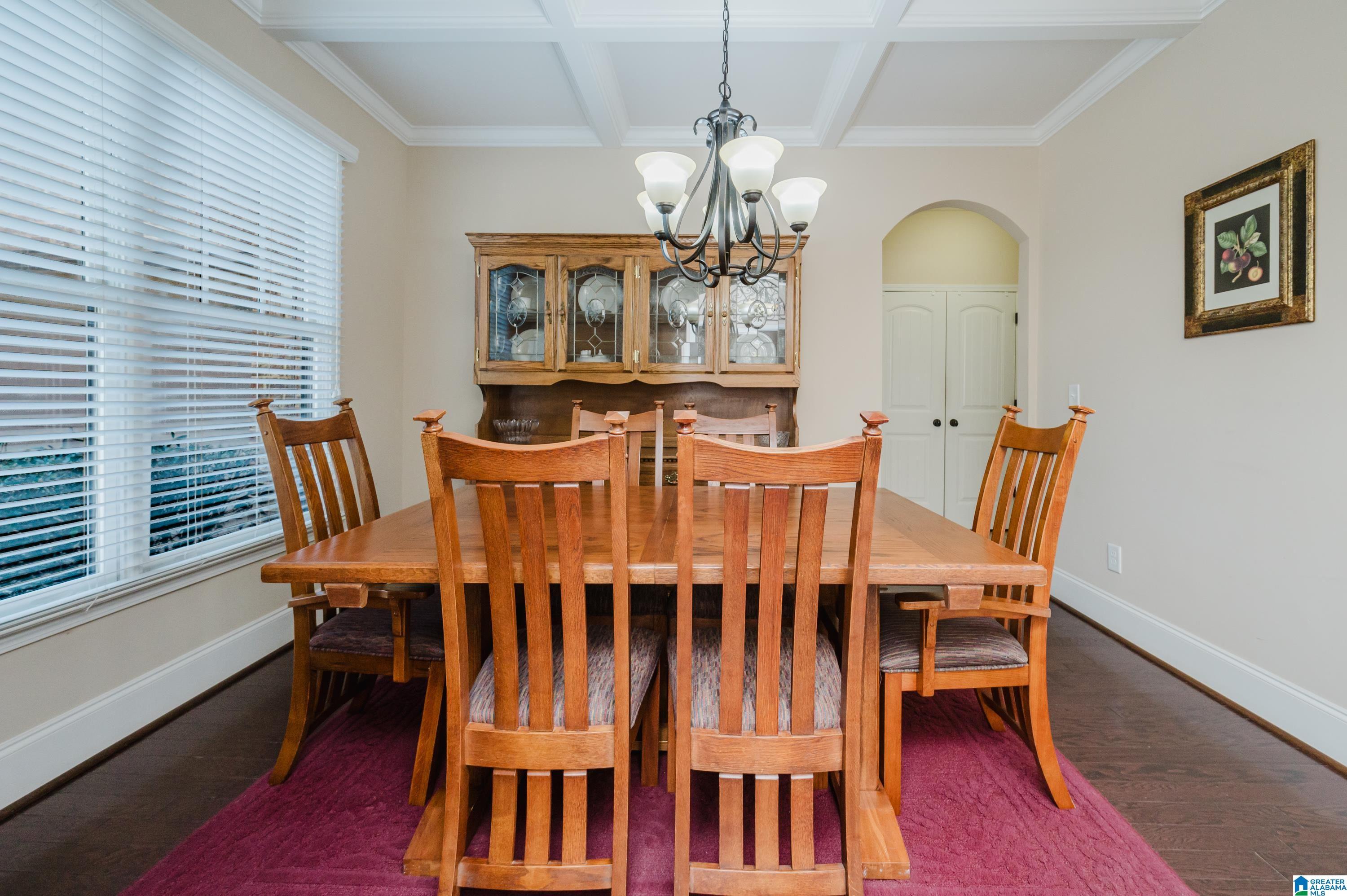 Image 2: Formal dining room with coffered ceiling