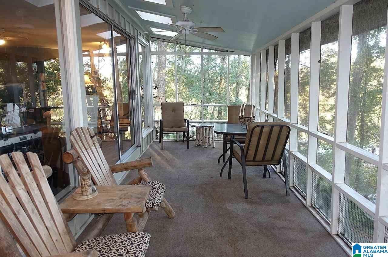 Image 4: BACK PORCH OFF LIVING ROOM - LAKE IN BACKGROUND