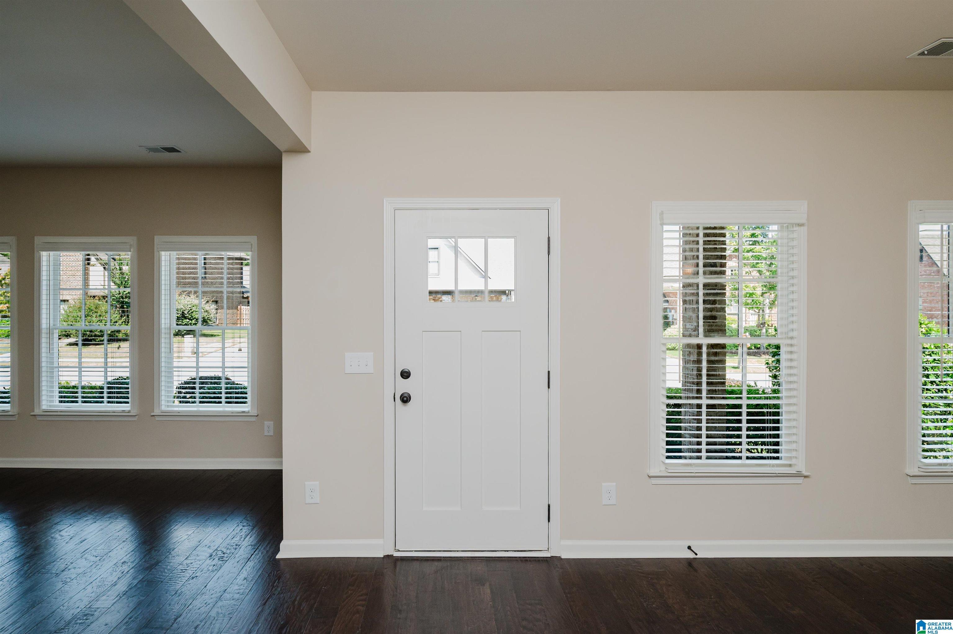 Image 4: Entry open to dining room and living room