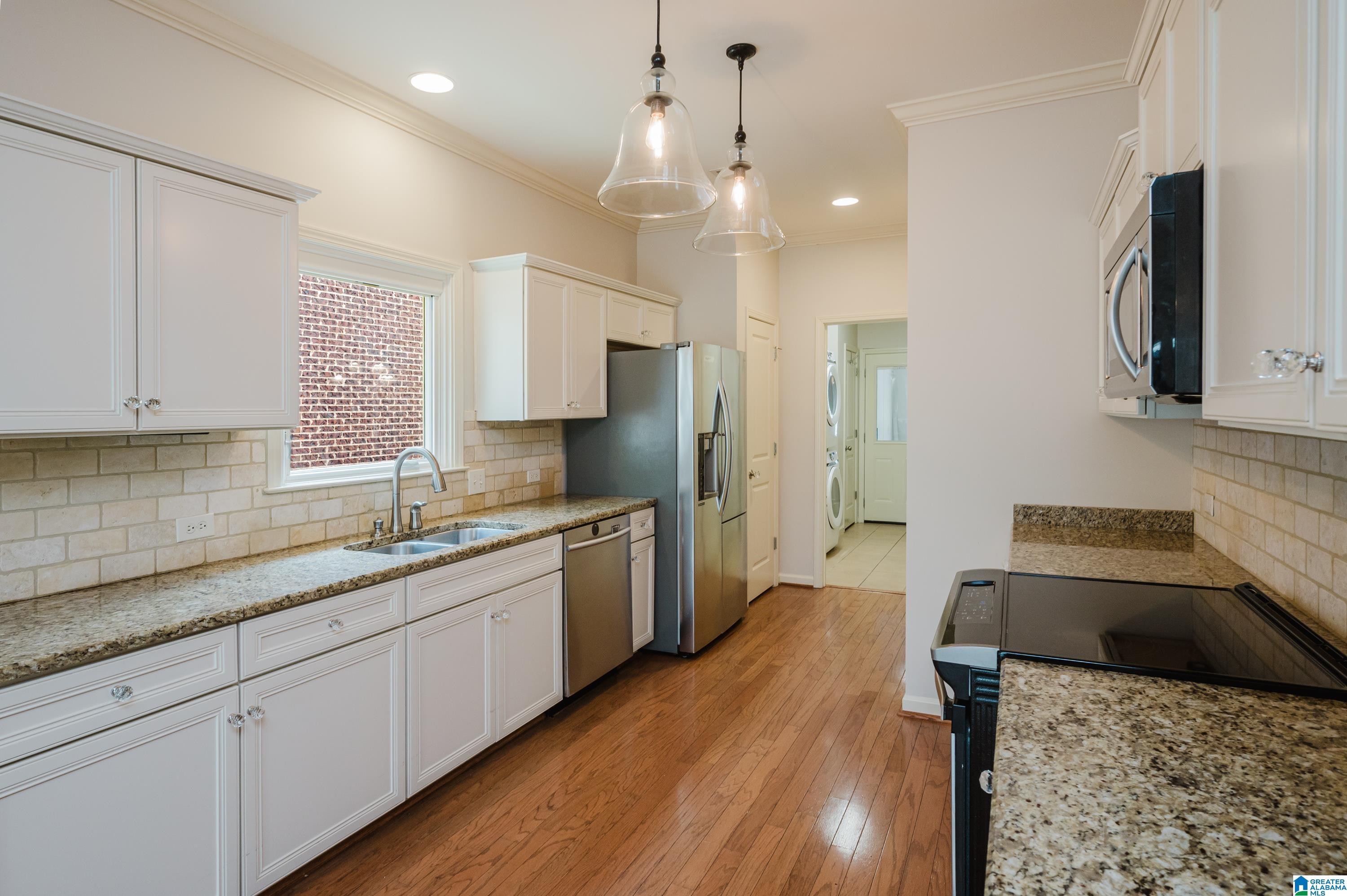 Image 4: Galley kitchen with stainless appliances