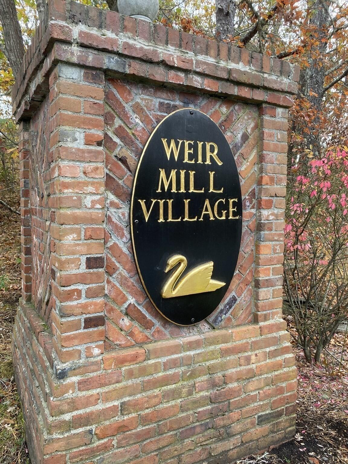 Image 1: Weir village sign