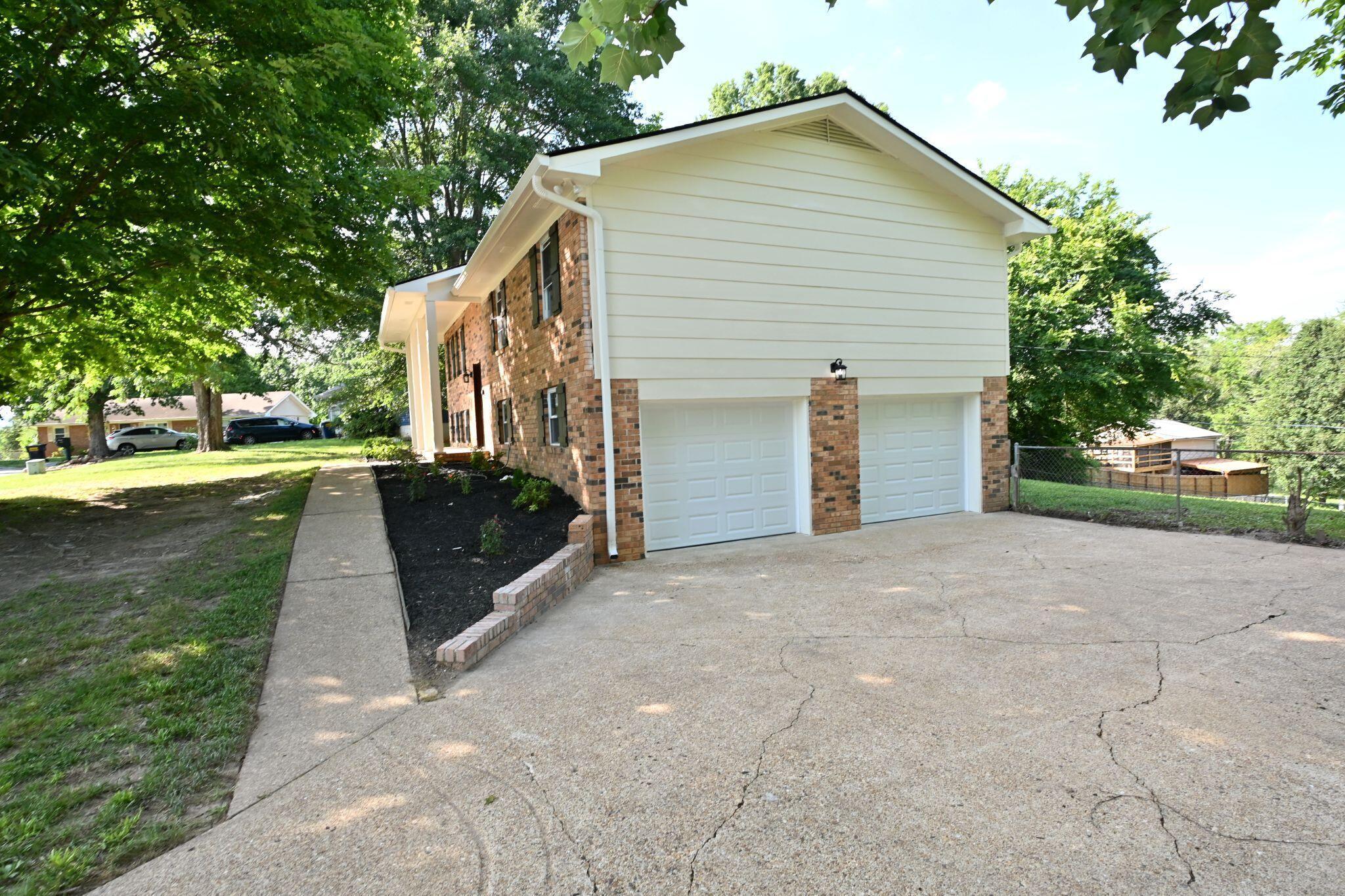 Image 3: New garage doors & cement board siding.