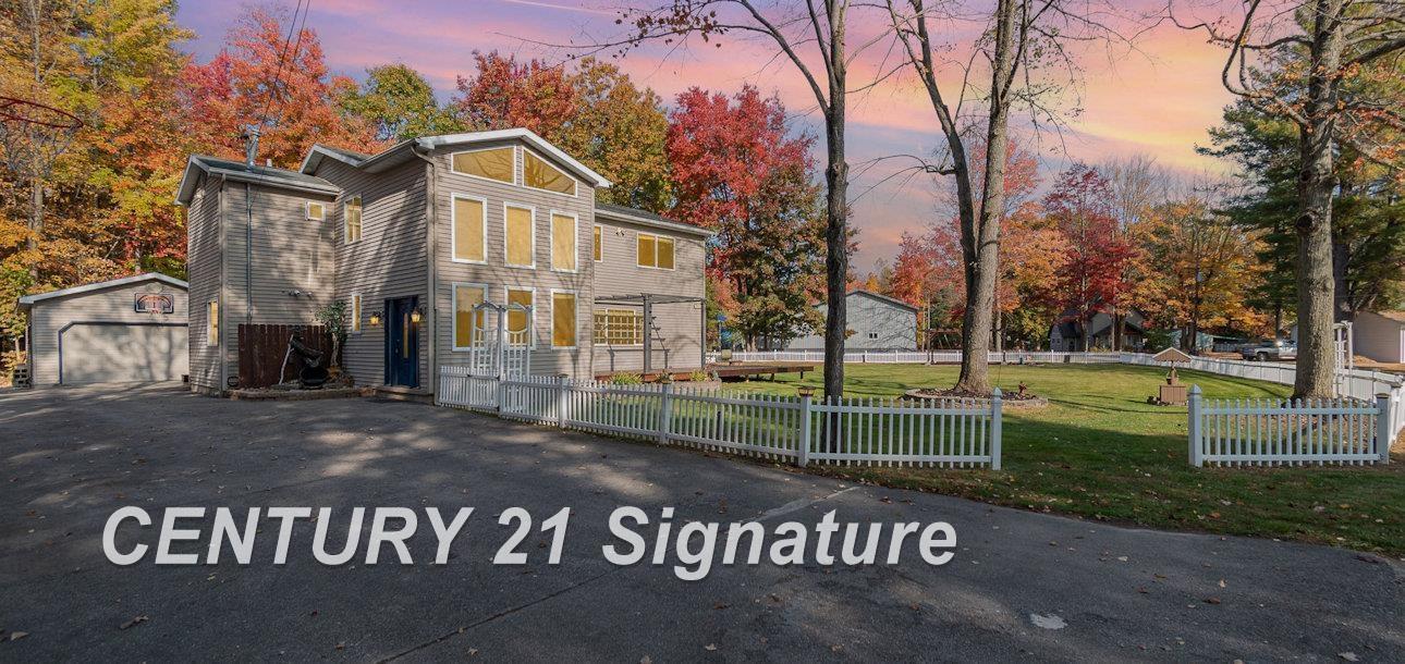 Image 1: Located on a rare double lot and includes private deeded boat launch access on Wixom Lake.  (Formerly 7451 & 7455 Narragannett)