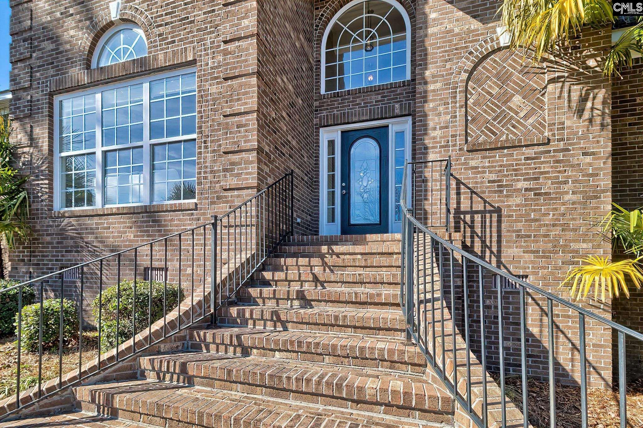 Image 2: Welcoming Entry with Flared Brick Stairs
