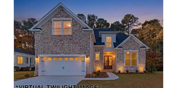 Image 1: Beautiful brick and Hardiplank exterior combines classic style with lasting curb appeal., Brick and Hardiplank Siding